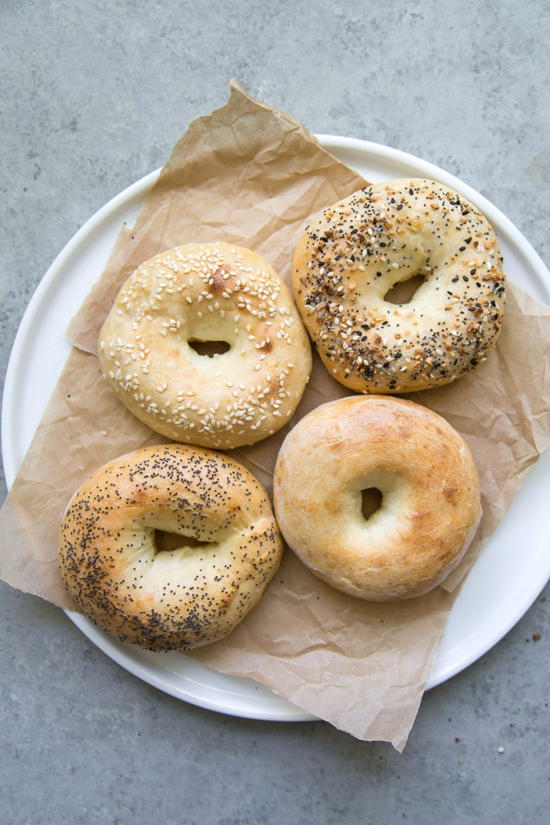 overhead shot of 2 Ingredient Bagels on a white plate lined with parchment paper