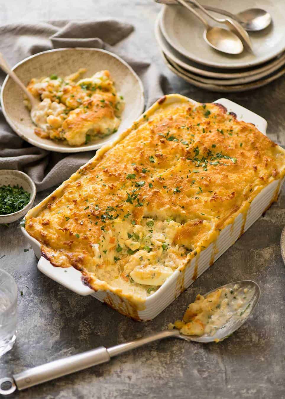 Fish Pie in white baking dish with serving plates
