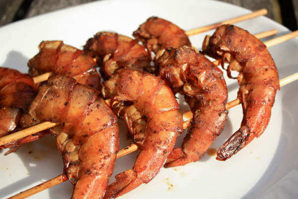 A Pair of Shrimp Skewers On a White Platter